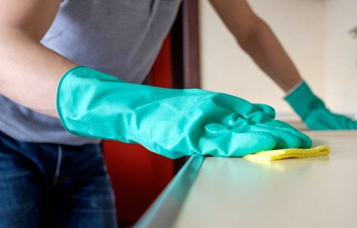 Technician handling cleaning waste in line with regulations